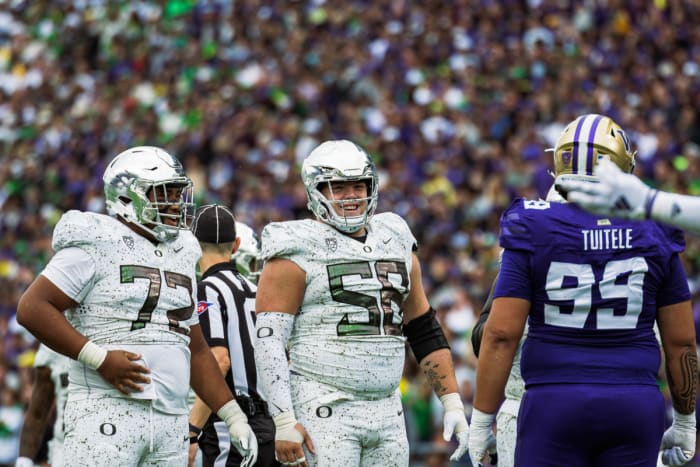 Oregon Ducks offensive lineman Iapani Laloulu (72) with center Jackson Powers-Johnson (58) during a game against the Washington Huskies.